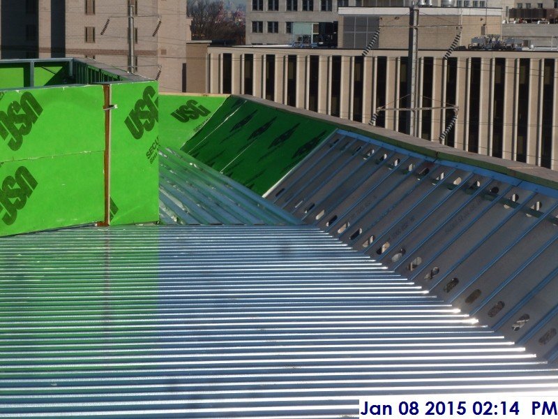 Installing sheathing along the high roof South Elevation